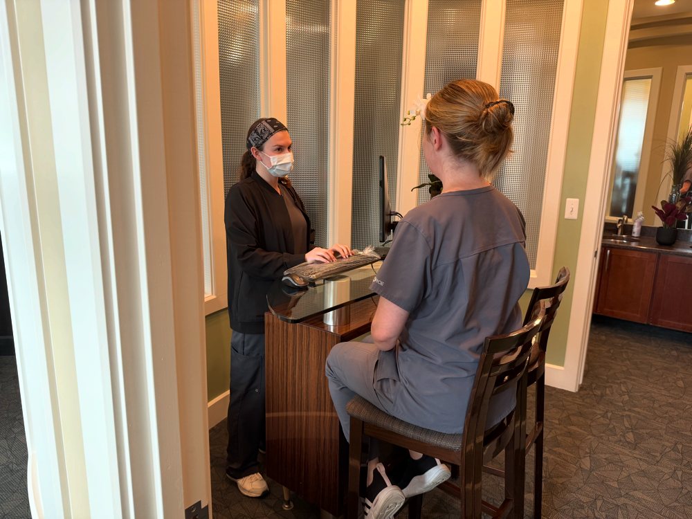 A parent checking in at the front desk of Lakes Pediatric Dentistry